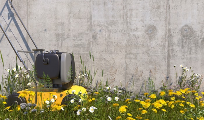 Une tondeuse à gazon jaune entourée de fleurs indigènes.