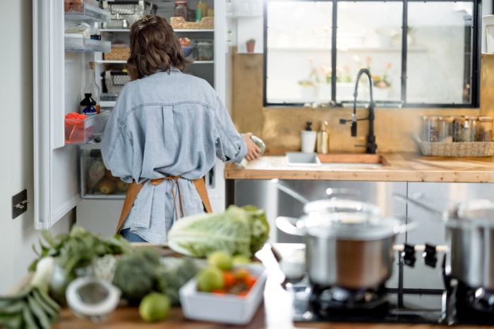 cuisine sale - femme regardant dans le réfrigérateur