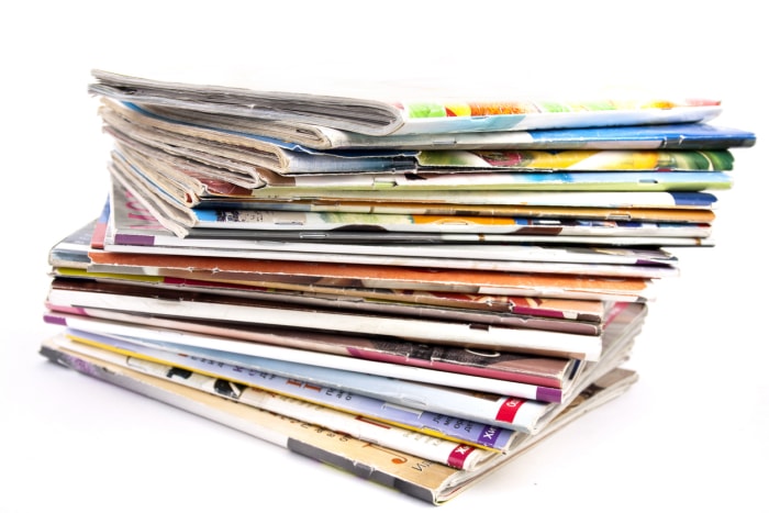 Pile de magazines isolée sur fond blanc.