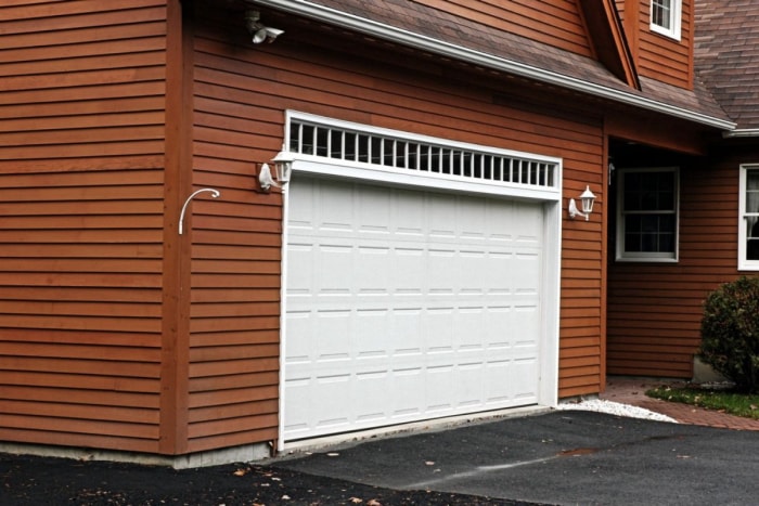 Vue d'un garage au bardage brun. 