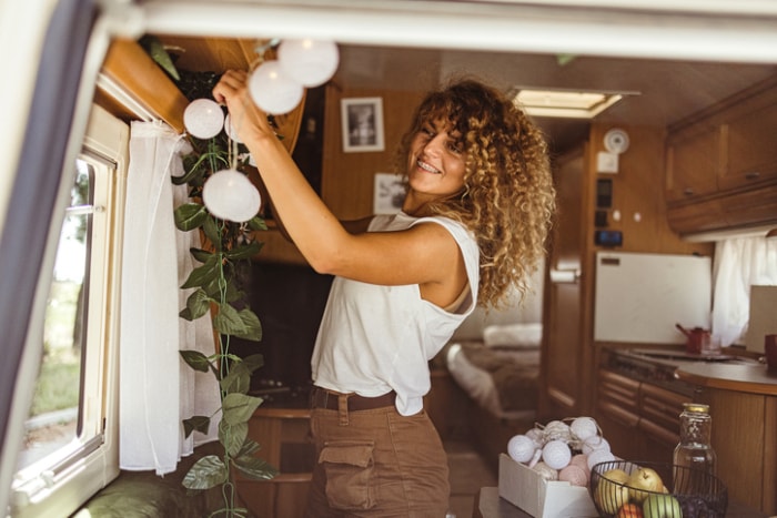 camper-decor-woman-hanging-wall-decor-in-rv