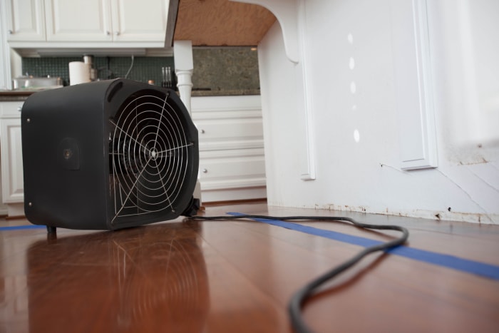 Un ventilateur sèche la cuisine après une inondation ou une fuite