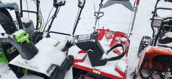 Une photo en gros plan d'une souffleuse à neige à un étage après utilisation avec de la neige dessus