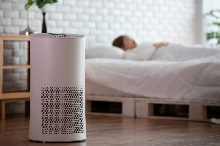 Purificateur d'air à côté d'une femme endormie