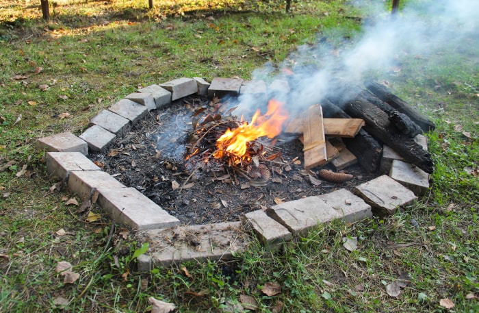 Foyer de bricolage mal construit avec un feu brûlant à l'intérieur