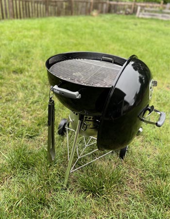 Le gril à charbon de bois Weber Original Kettle Premium installé dans un jardin