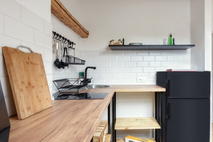 Petite cuisine d'angle avec table en bois.