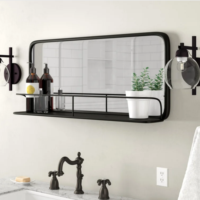 Petit miroir de salle de bain noir avec une étagère en métal intégrée dans son cadre