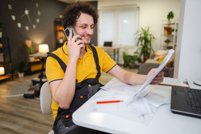 Craftsman calling colleague on the phone asking for instructions