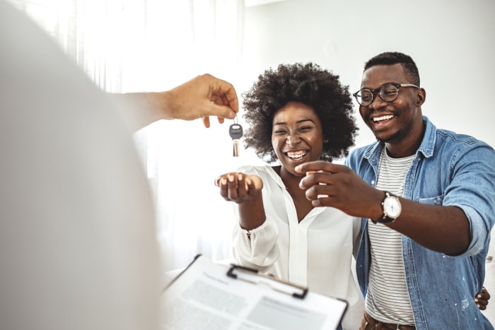 Jeune couple amoureux qui démarre sa vie de famille, a eu la chance d'acquérir une propriété indépendante, a reçu la clé du nouvel appartement, location sociale, achat d'un nouvel appartement, rencontre avec un agent immobilier