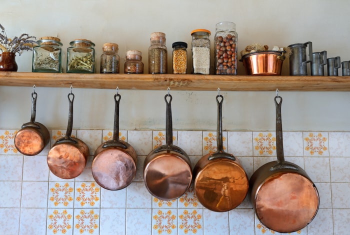 copper cookware hanging in kitchen