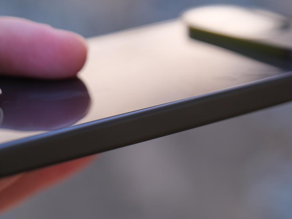 A soft focus image of the side of the Google Pixel 9.