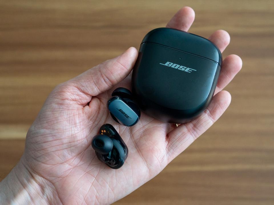 Bose QuietComfort Ultra earbuds in a palm