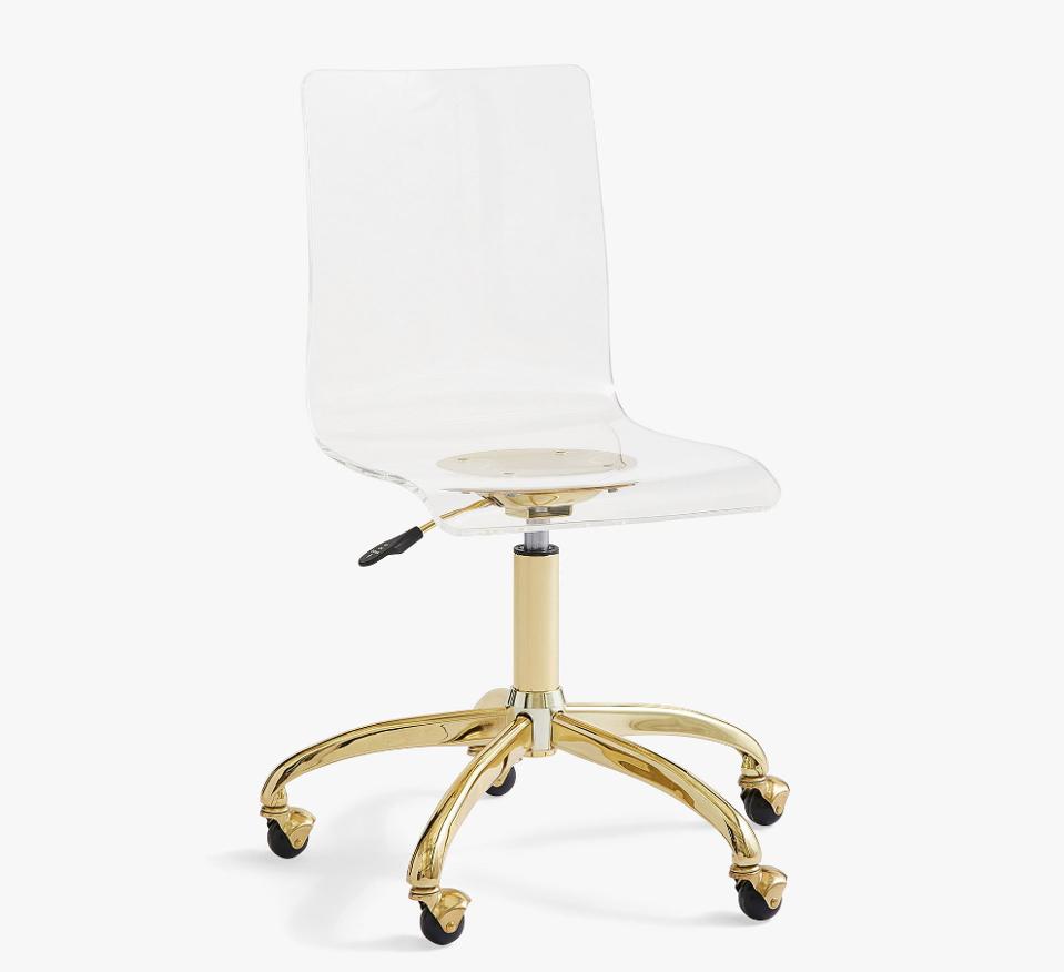 Acrylic chair with gold base on a white background