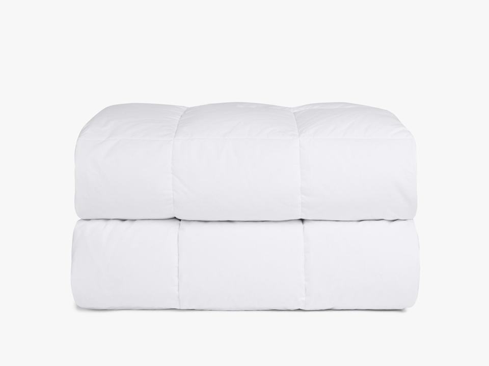 White Down Mattress Pad folded against a white background.