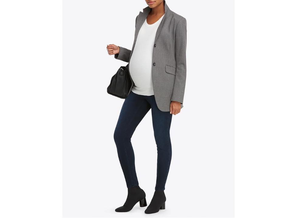 standing mom wearing blue spanx Mama Ankle Jean-ish Leggings & white top gray suit jacket