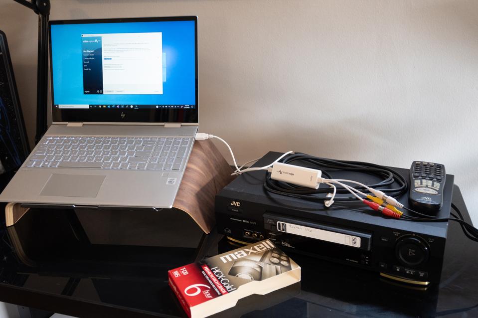 A VCR, laptop and video converter ready to transfer videotapes to digital. 