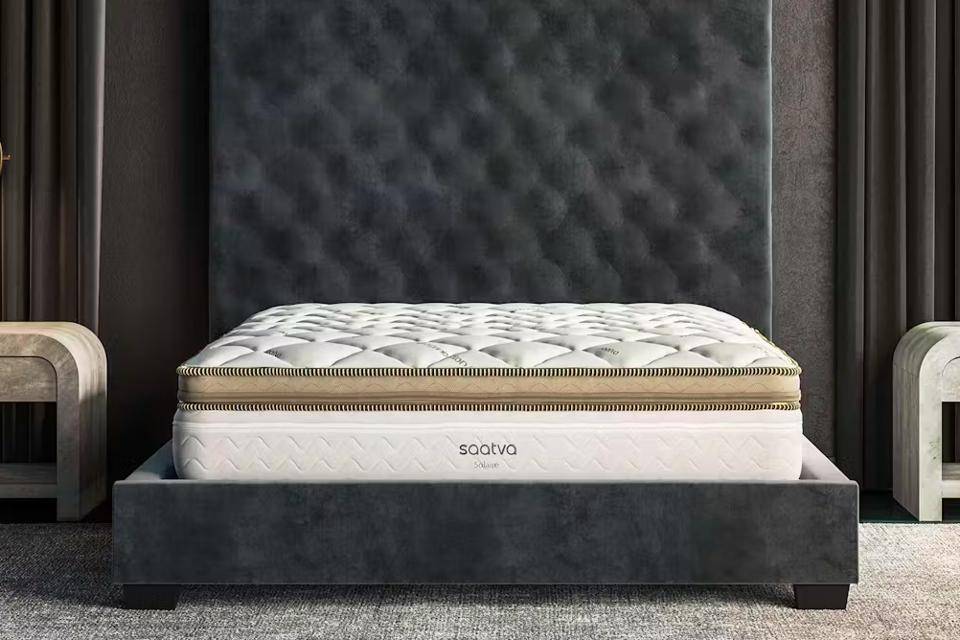 Solaire Adjustable Firmness Mattress on a grey upholstered bed frame.