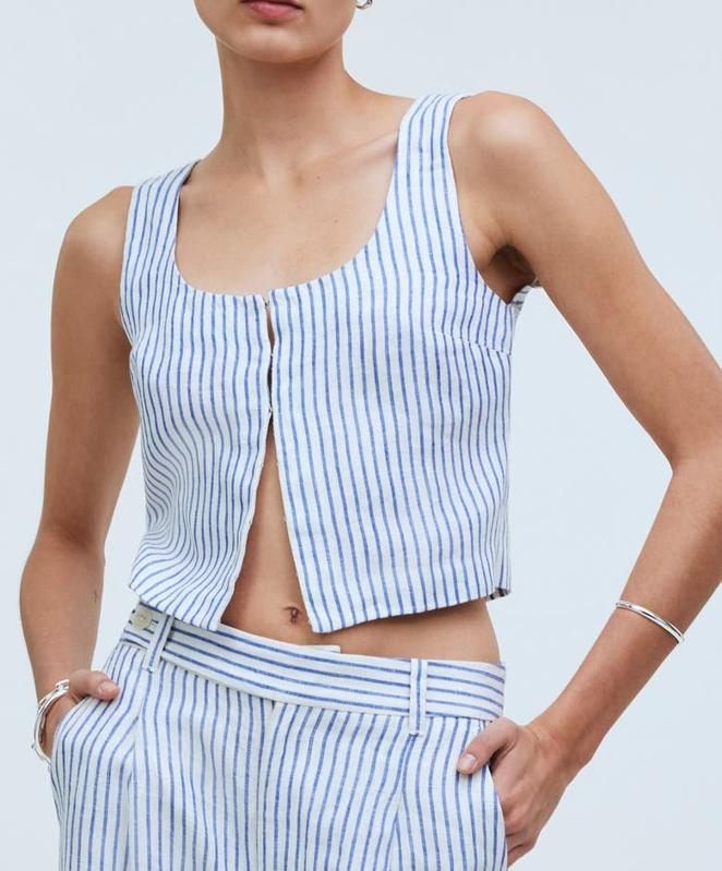 Woman wearing a blue and white striped Madewell Stripe Scoop Neck Crop Tank. 