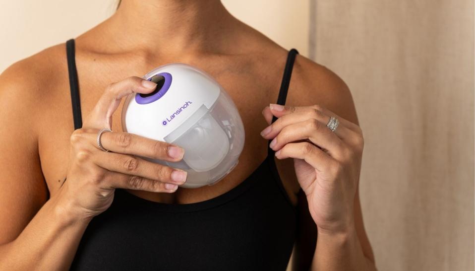 Woman Placing Lansinoh Discreet Duo Wearable Pump in her bra