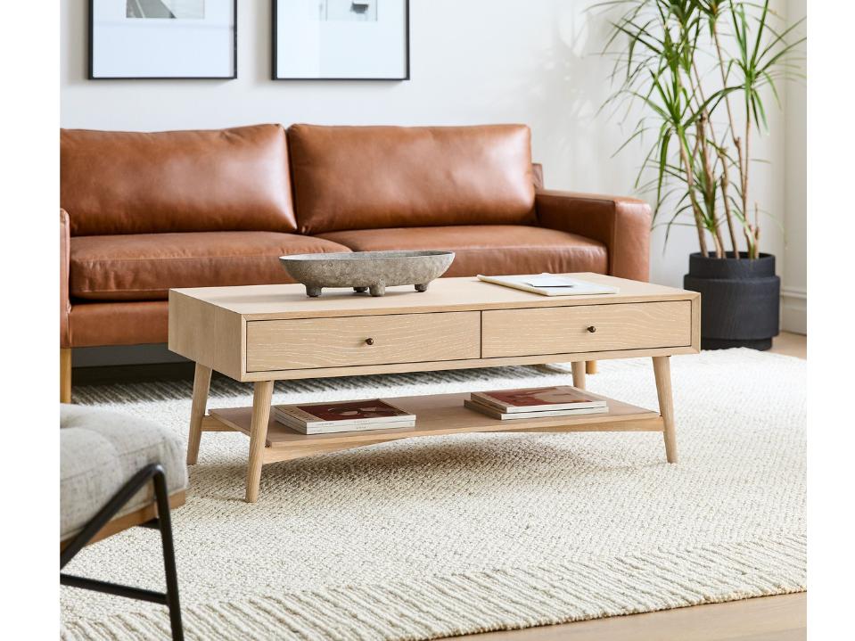 cerused white Mid-Century Storage Coffee Table (47.5-Inch) on beige rug in living room in day