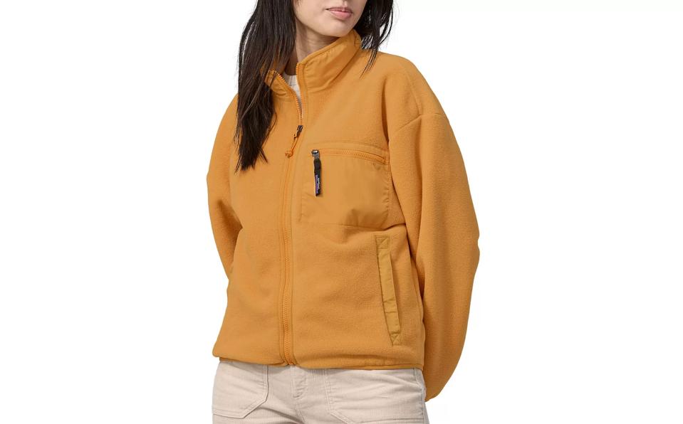 Woman in a Mango Yellow Patagonia Synchilla Jacket.