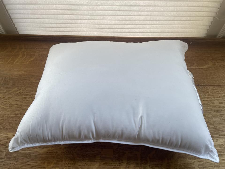 The best value pillow, the Amazon Basics Down Alternative, on the floor