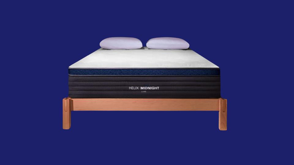 A white, gray and black Helix mattress on a navy blue background