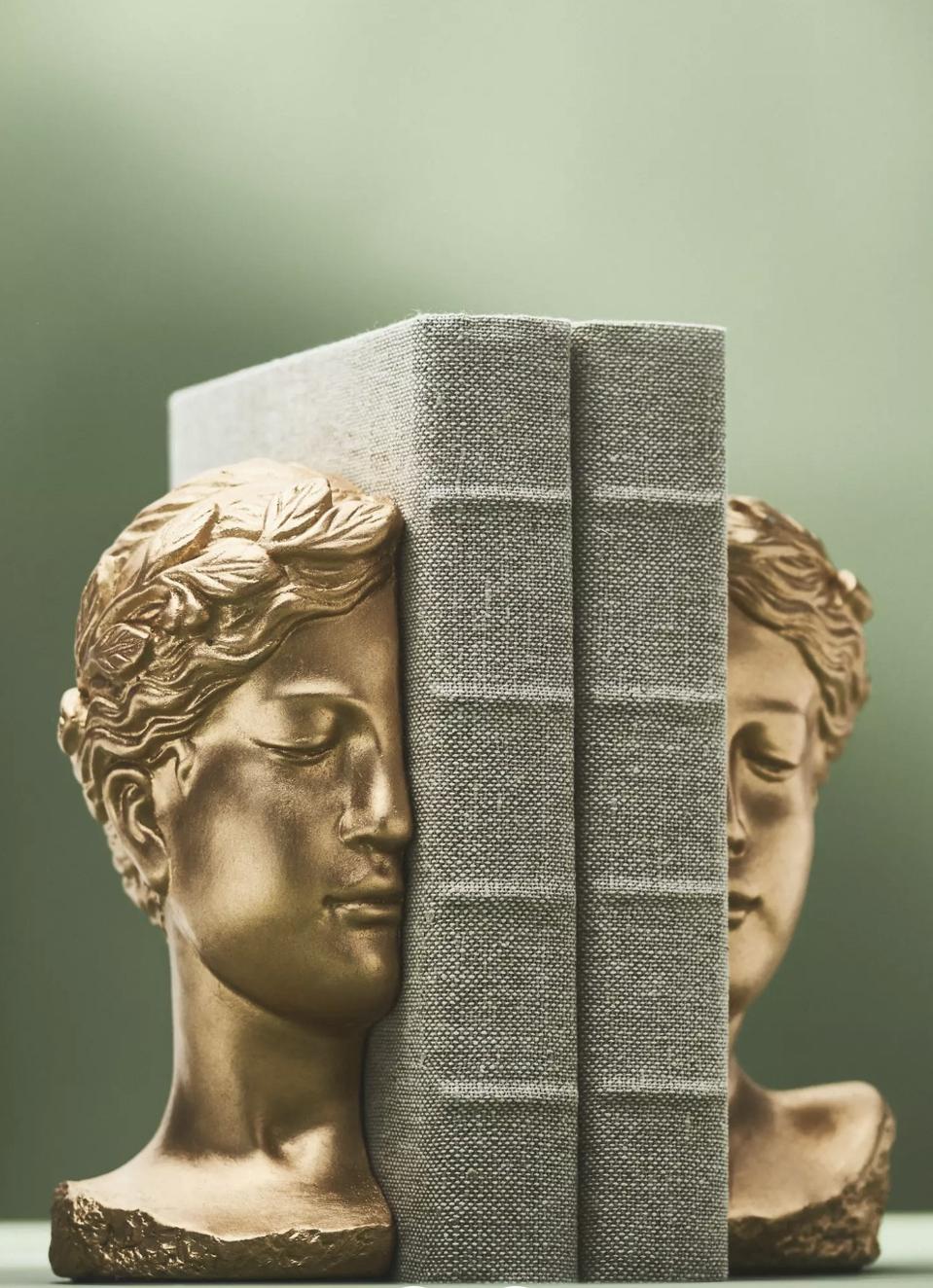 set of two cement bookends in shape of woman's bust