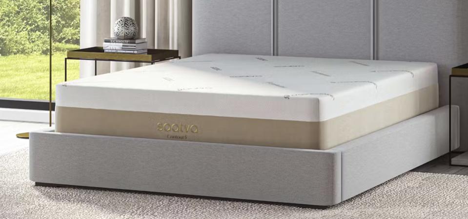 The Saatva Contour5 mattress on a light grey bed frame.