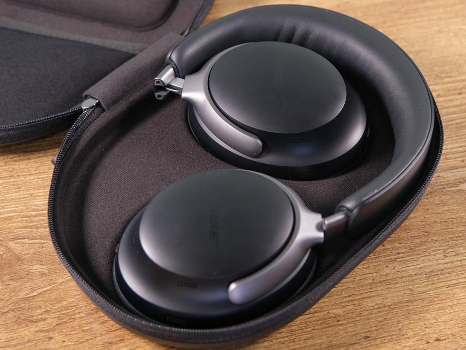 Black Bose QuietComfort Ultra headphones in their case.