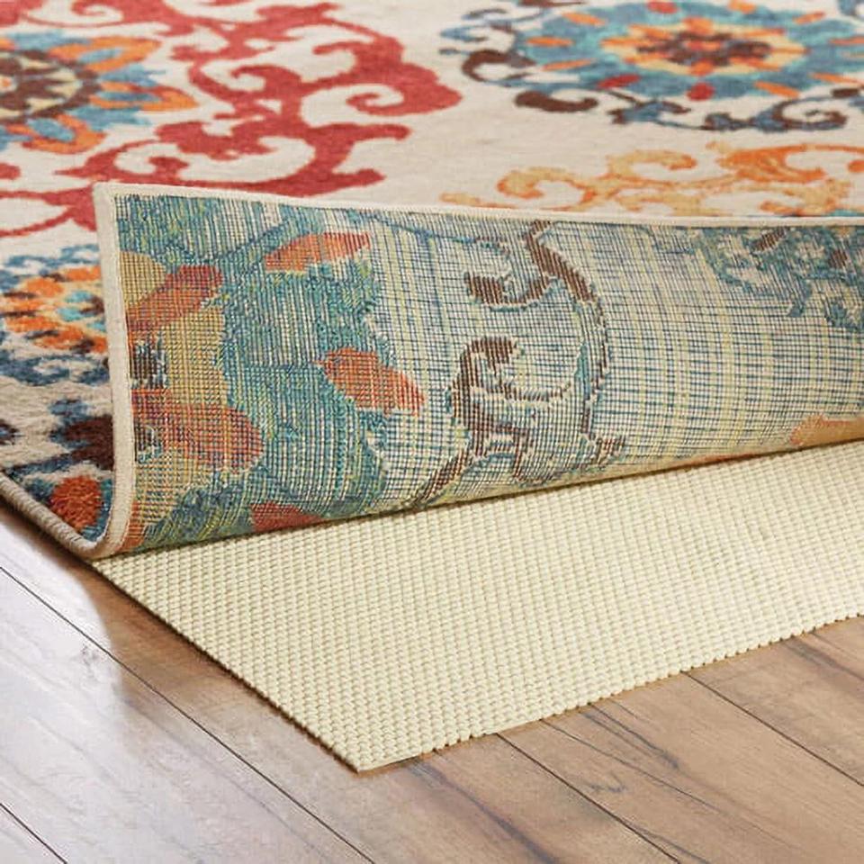 Better Homes & Gardens Cushioned Nonslip Rug Pad underneath a colorful rug.