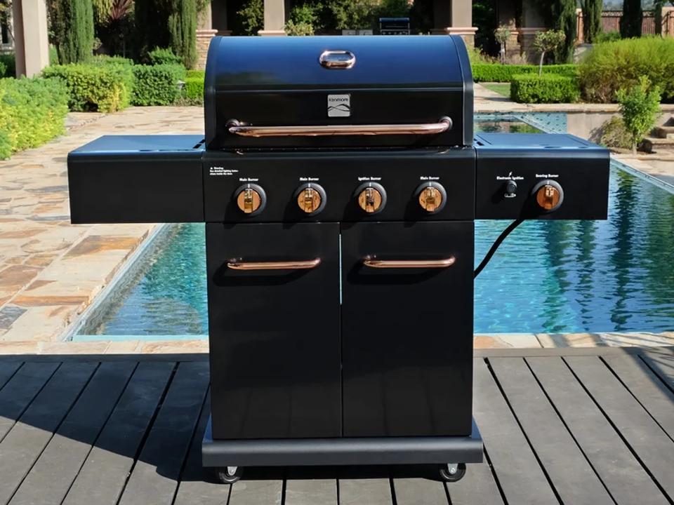 Kenmore Four-Burner Propane Gas Grill on patio near pool.