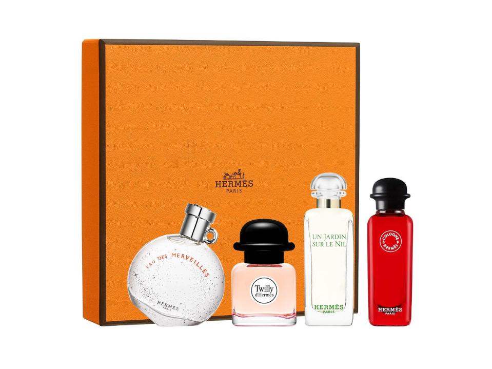 4 perfume bottles from HERMÈS Mini Fragrance Discovery Set w/ orange box behind them