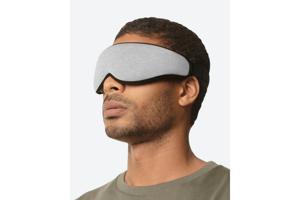 A man wearing the Ostrichpillow Eye Mask against white background.