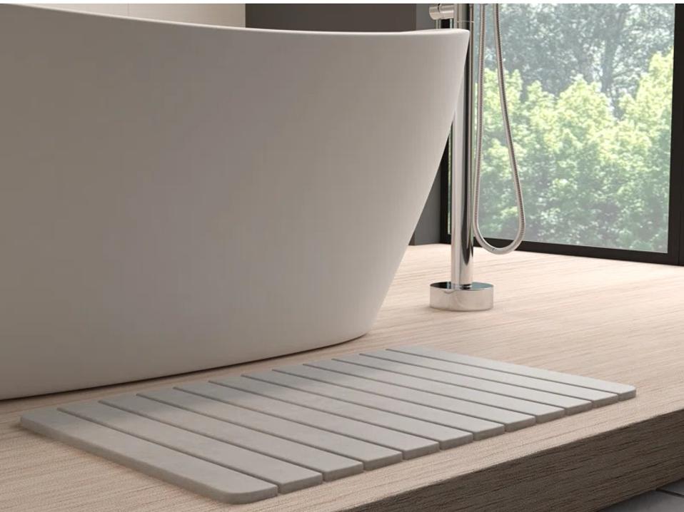 Houchens Diatomite Bath Mat next to a freestanding tub.