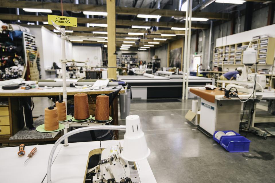 A sewing room with industrial machines inside Patagonia's design center, the Forge.