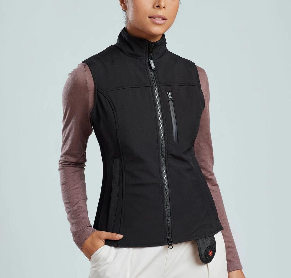 Woman wearing a heated vest in black