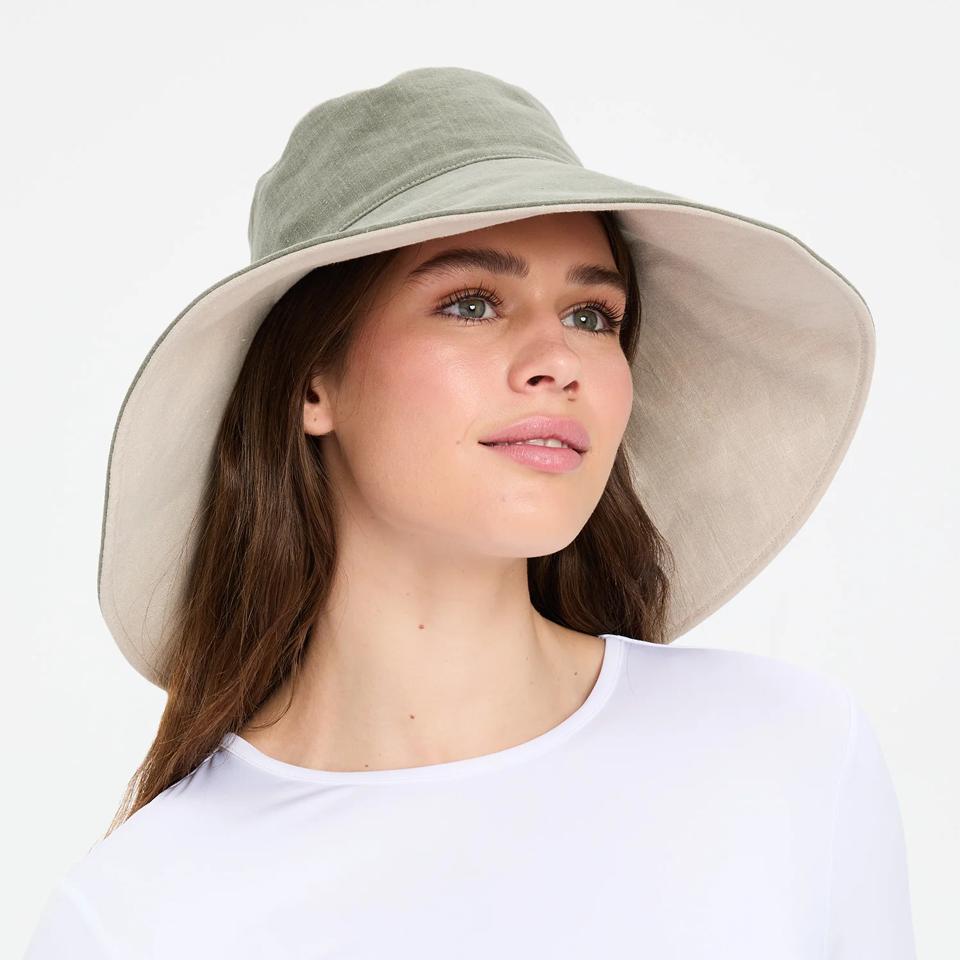 Solbari Ultra Wide Cotton Linen Hat UPF 50+ on a model.