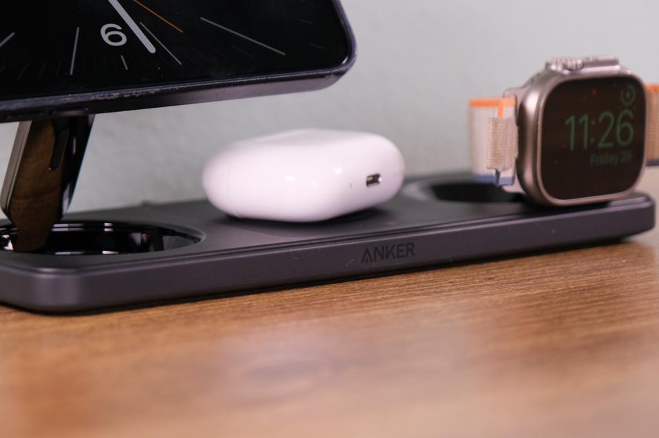 A close up of the charging station with AirPods and an Apple Watch