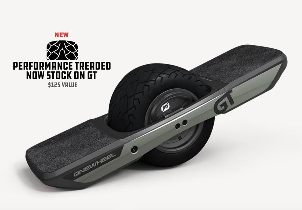 Onewheel GT green and black electric skateboard with one wheel on a grey background