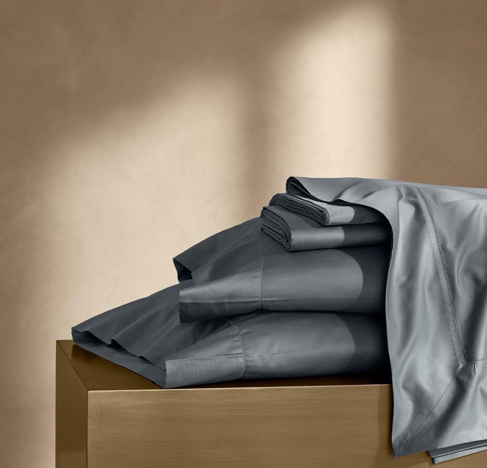 The Boll & Branch Summit Supima Sheet Set in Bluestone on a gold background