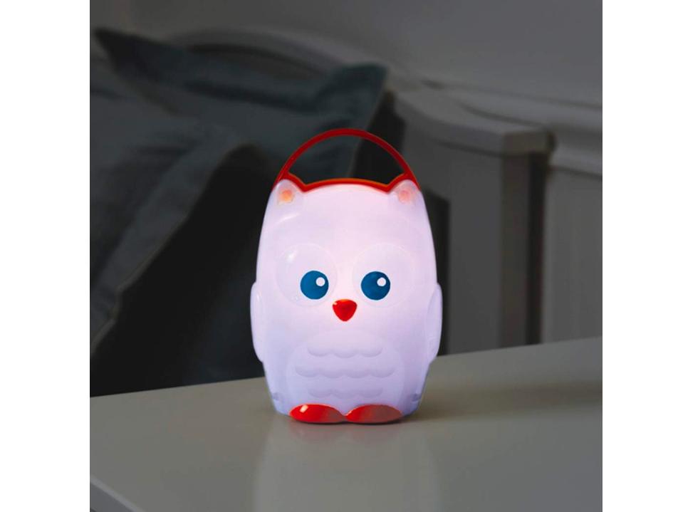 Munchkin Light My Way Night Light glowing on nightstand next to bed best night lights