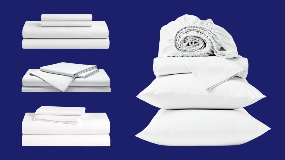 Four stacks of white hotel sheets on a blue background