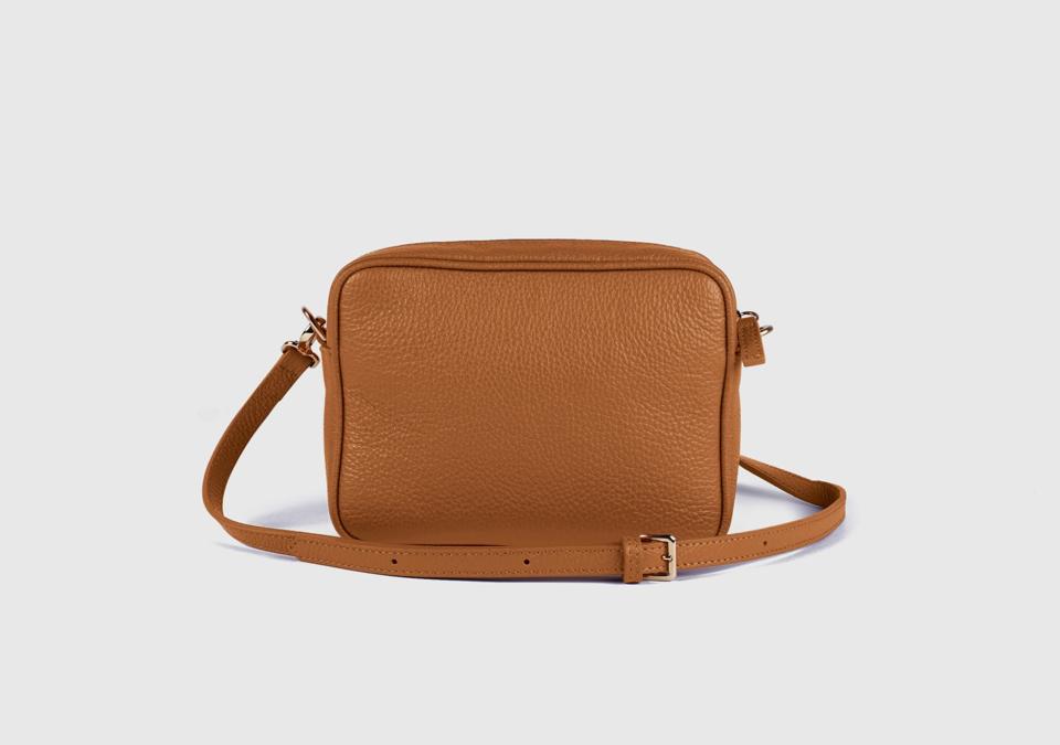 product shot of a Quince Italian Leather Crossbody Bag in the cognac colorway.