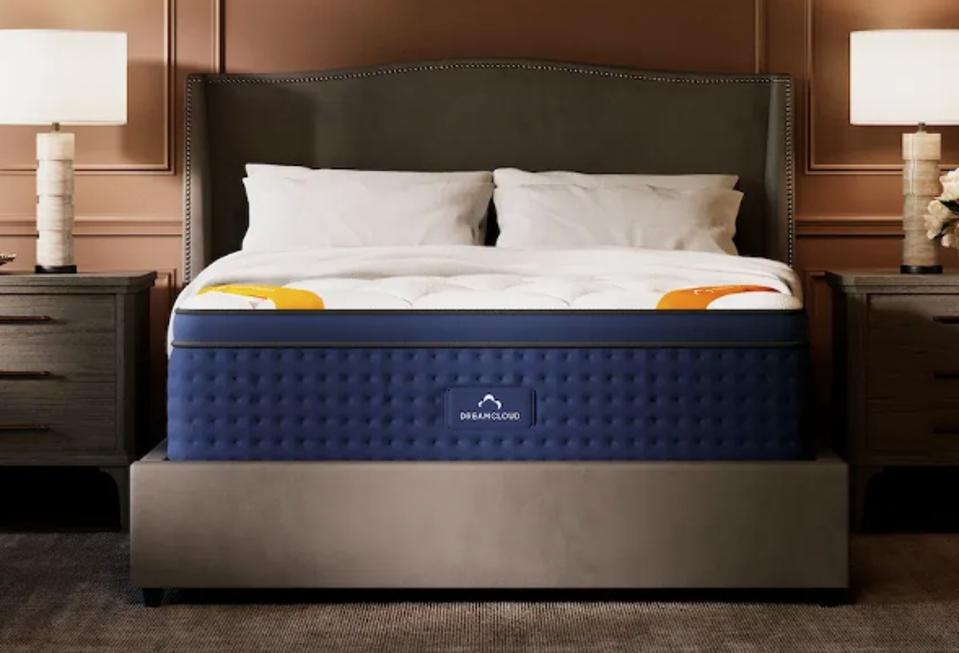 The DreamCloud Premier Rest in a bedroom in between nightstands with lamps on them