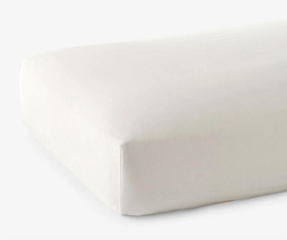 The Company Store fitted sheet in white on mattress against white background.