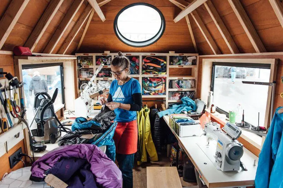 A woman repairs clothing in the Patagonia Worn Wear truck