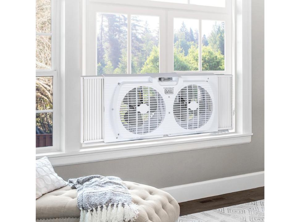 white Black+Decker 9-Inch Dual Window Fan in bedroom window in daytime