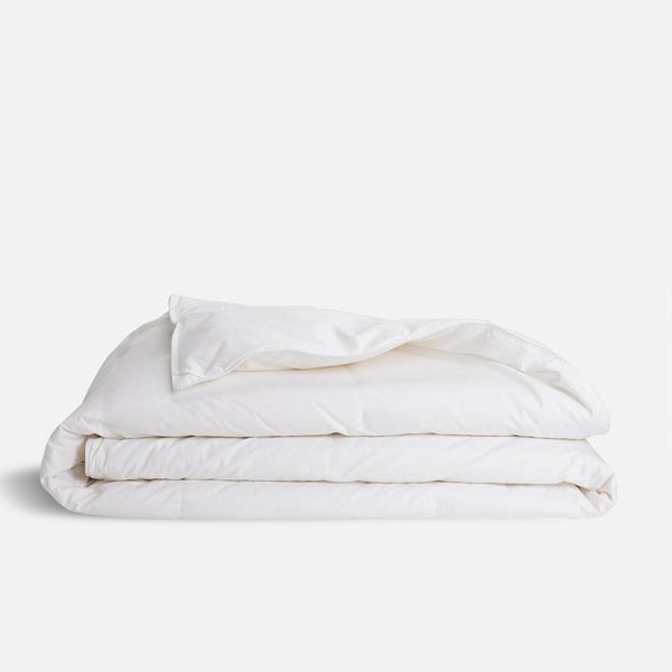 Brooklinen's down comforter folded on itself on a white background. 